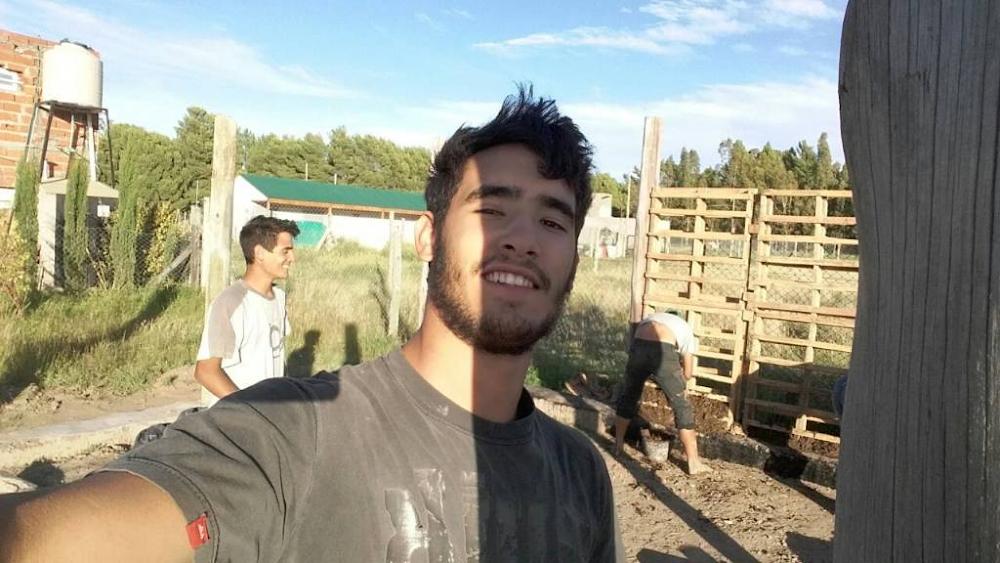 Lucas en primer plano y Agust&iacute;n a la izquierda, ambos riendo durante la bioconstrucci&oacute;n de la casa de barro de Alma de Hornero en Bah&iacute;a Blanca.