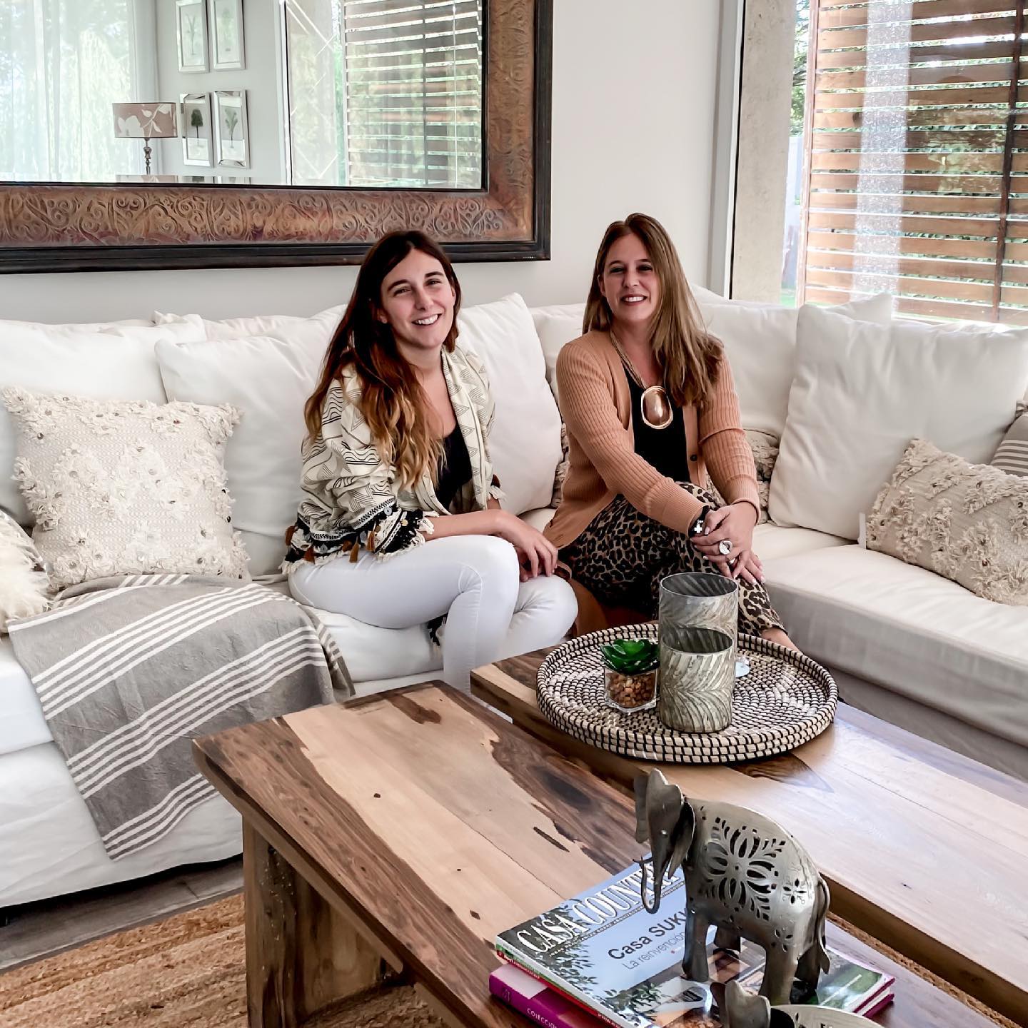 Las dos hermanas al frente de Ideas Deco Home, sentadas en un living del local.