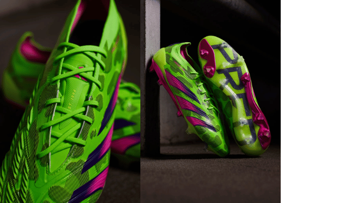 Chuteira Adidas Predator 24 Lowcut FG Generation verde, rosa e roxa em pé sobre grama verde. A chuteira tem um design leve e respirável com uma combinação de cores verde solar e rosa choque acentuada por um gráfico de leopardo. A parte superior da chuteira é feita de material Hybridtouch para chutes precisos e controle de bola superior.