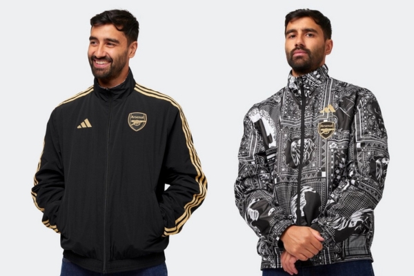 Jaqueta Revers&iacute;vel Anthem Arsenal x Ian Wright Adidas 2023-2024 em preto, cinza e dourado. Design exclusivo homenageando o legado de Ian Wright com gr&aacute;ficos inspirados em sua carreira no futebol
