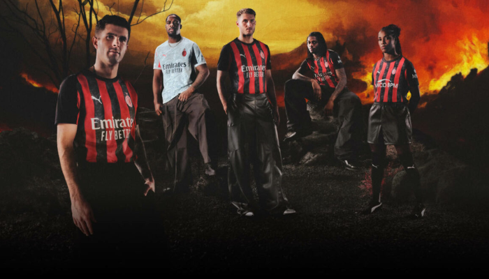 Camisa titular AC Milan Puma 2025/26 versão jogador com listras em chamas, vermelho e preto, gola preta.
