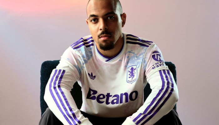 Terceira camisa Aston Villa Adidas 2025/26 branca com padrões coloridos em azul-celeste, rosa e roxo e gola V com frisos.