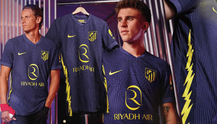 Camisa Reserva Atlético de Madrid 2025/26 Nike, azul marinho com raios laterais, escudo, Swoosh e patrocinadores em amarelo neon