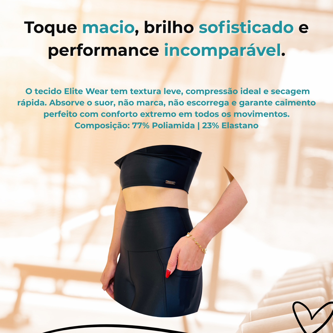 A imagem é um anúncio destacando o conjunto esportivo composto por um top cropped e um short de cintura alta. O texto enfatiza as qualidades do tecido Elite Wear, como toque macio, brilho sofisticado e performance incomparável. O material é descrito como tendo textura leve, compressão ideal e secagem rápida. Ele absorve o suor, não marca, não escorrega e proporciona um ajuste perfeito com extremo conforto em todos os movimentos. A composição do tecido é de 77% poliamida e 23% elastano.