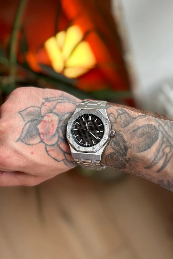 A person with tattoos on their arm

AI-generated content may be incorrect.