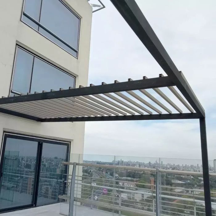 Pérgola en una terraza con columnas WPC atornilladas sobre una estructura metálica negra